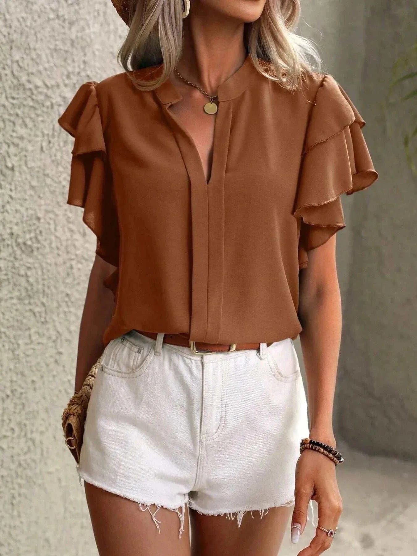 Brown ruffle sleeve notched blouse paired with white high-waisted shorts