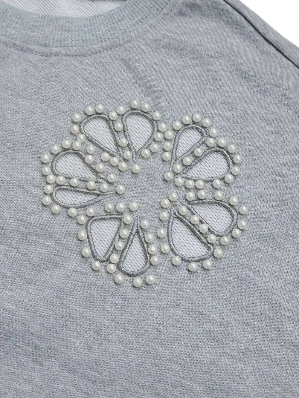 Gray long sleeve sweatshirt with cutout design and pearl embellishments around floral-shaped mesh