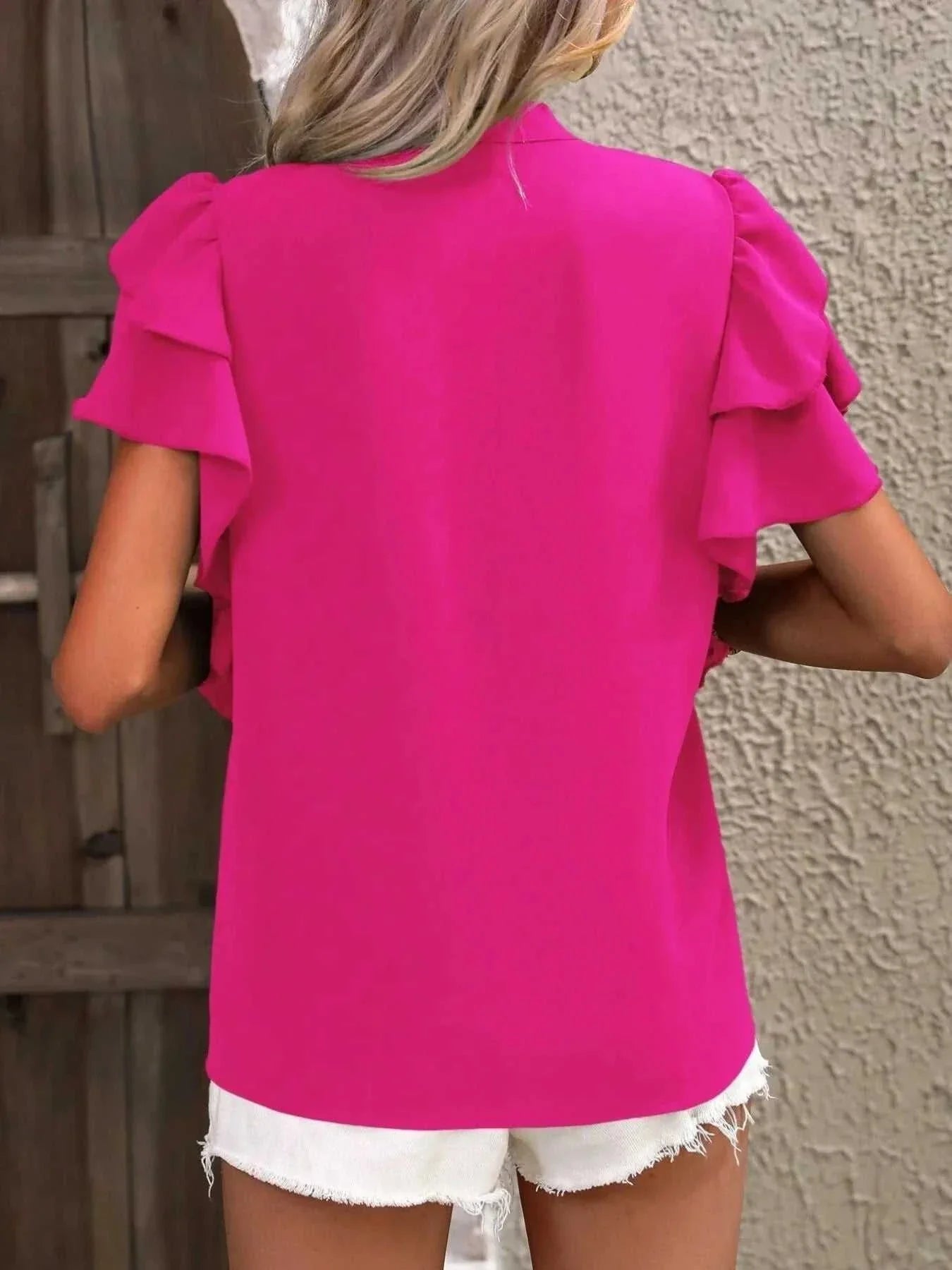 Bright pink ruffle sleeve notched blouse with layered sleeves in polyester fabric.