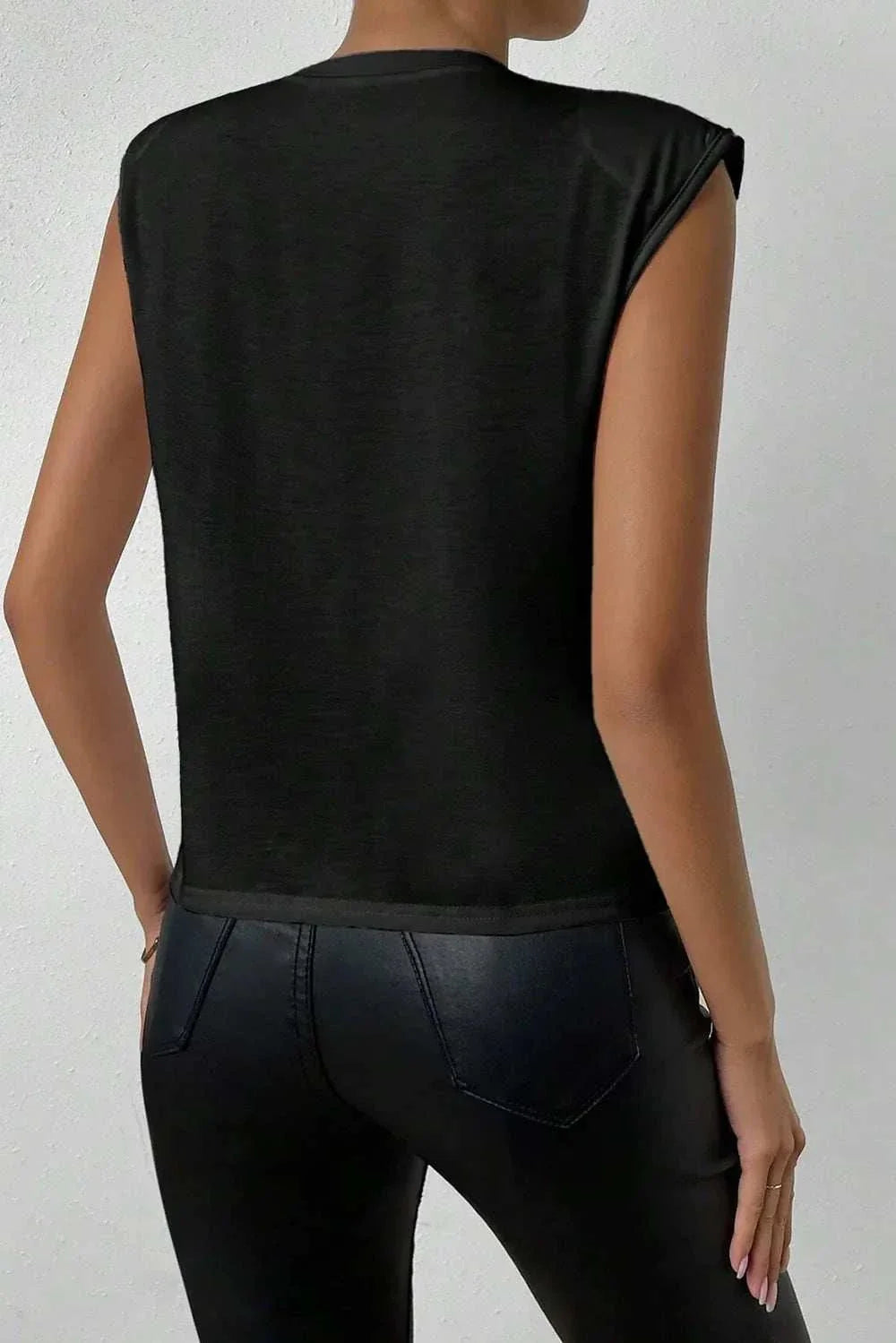 Black basic pearl detail round neck tank top with opaque fabric and no stretch, worn with black pants, back view