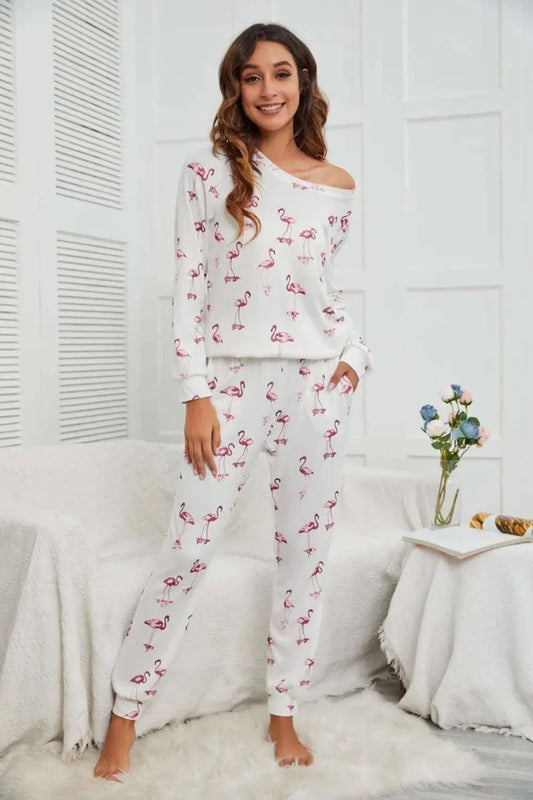 woman wearing white flamingo long sleeve top and pants lounge set standing in cozy room