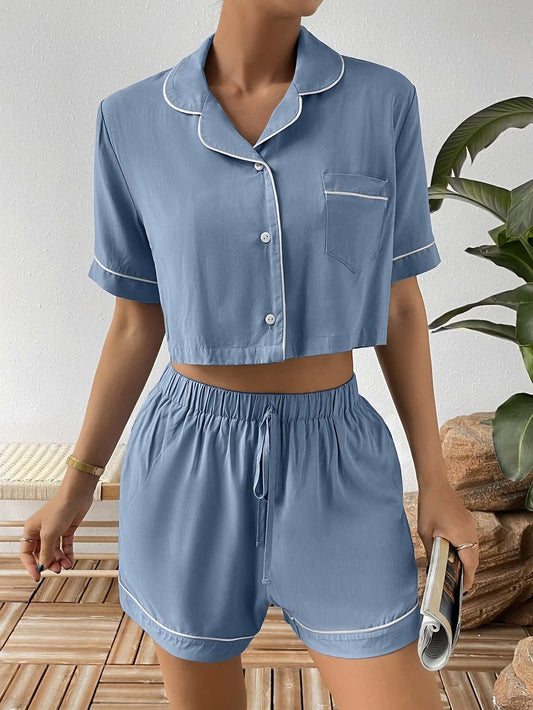 Ivy Lane Contrast Lapel cropped shirt and shorts lounge set in blue with white piping, buttoned short-sleeve top and elastic waist shorts.