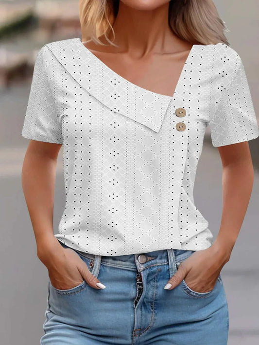 White eyelet asymmetrical short sleeve T-shirt with decorative buttons and slight stretch fabric.