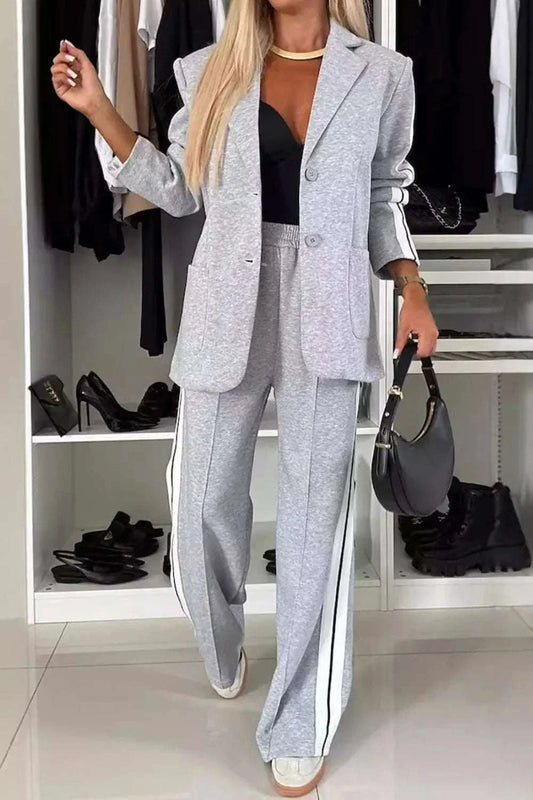 Full size women's two-piece gray contrast lapel collar top and pants set with buttons and pockets made of 100% polyester.