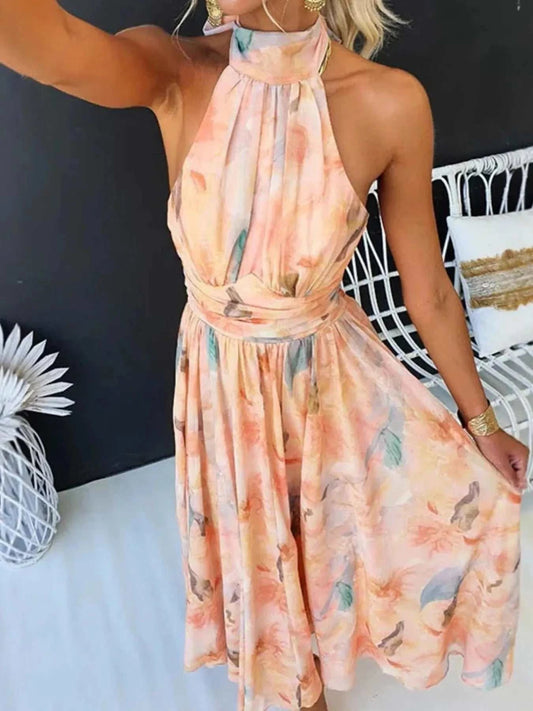Floral halter neck backless summer dress in soft pastel colors with tied waist and flowing skirt
