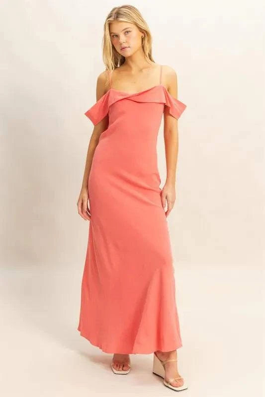 Woman wearing coral HYFVE Flattering Fit cami maxi dress with asymmetrical ruffled neckline and slim silhouette