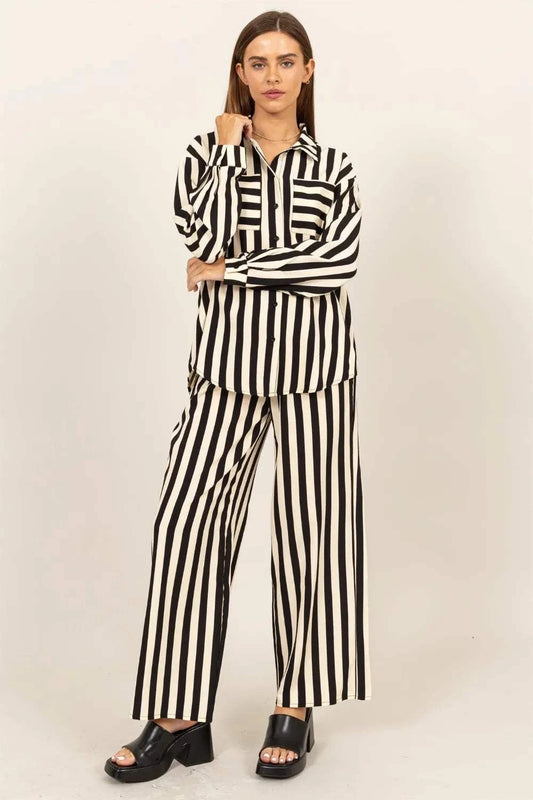 Woman wearing black and white striped button up shirt and wide-leg pants set with open-toe black heels