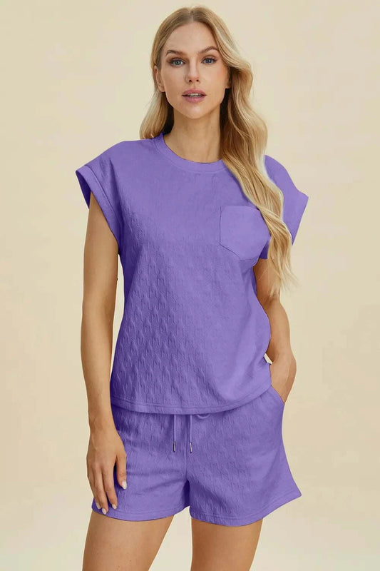 Double Take Full Size women's pocketed textured round neck top and shorts set in purple with slight stretch