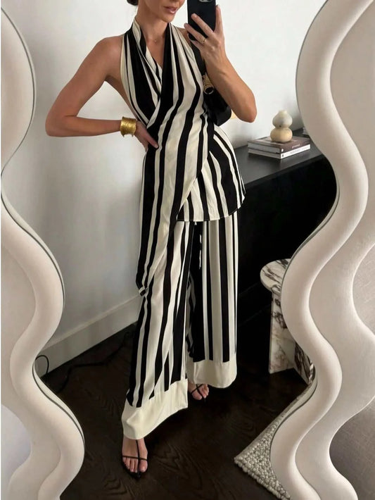 Woman wearing black and white striped halter neck top and matching wide-leg pants two-piece set