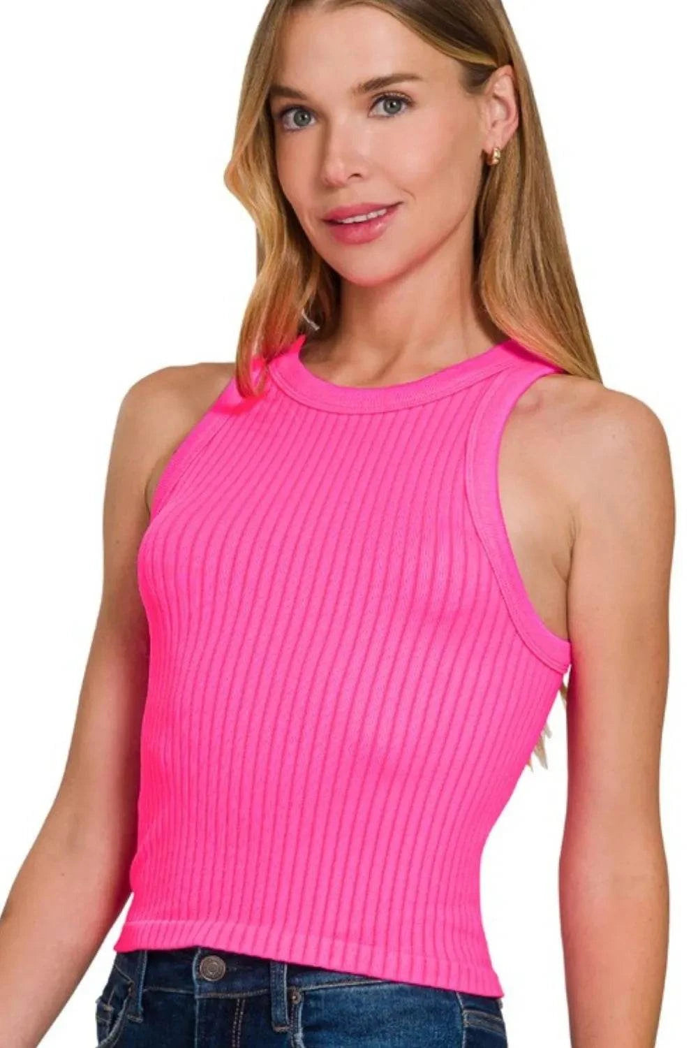woman wearing bright pink seamless ribbed crop tank with high neckline and sleeveless design