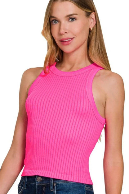 woman wearing bright pink seamless ribbed crop tank with high neckline and sleeveless design
