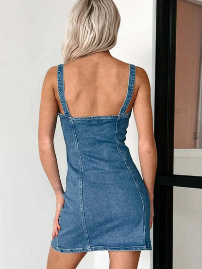 Back view of a woman wearing a button front sweetheart neck denim mini dress with wide straps.